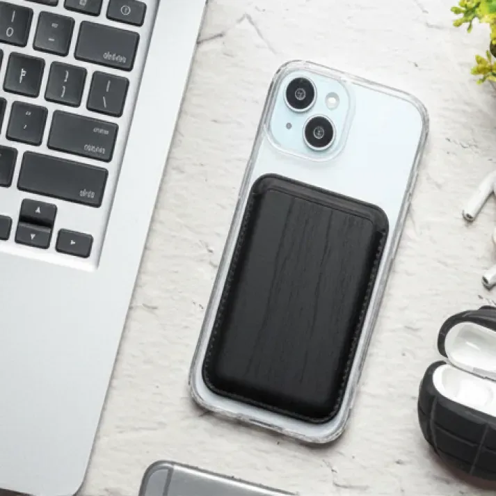 Black wooden texture MagSafe wallet attached to a clear iPhone case.